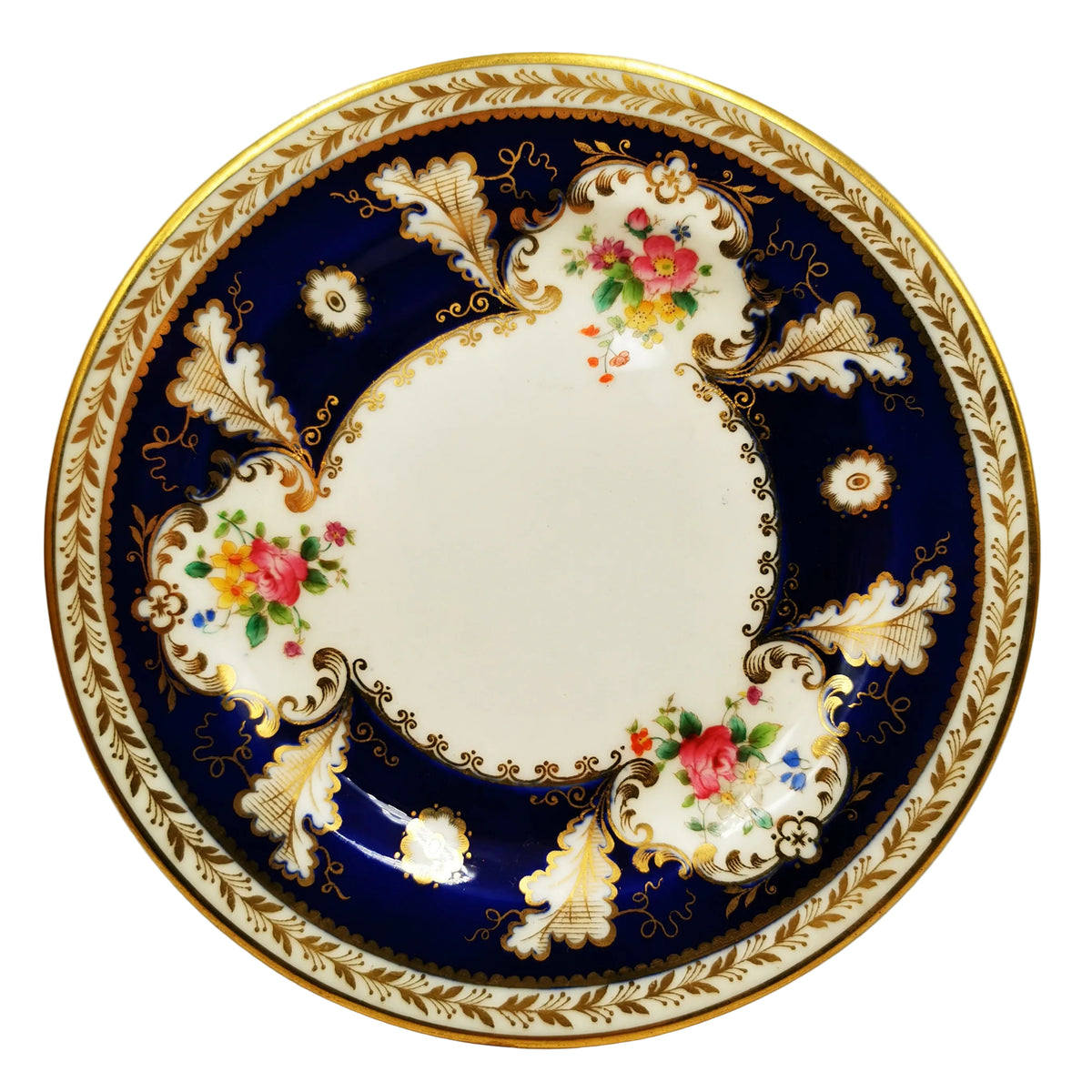 A round porcelain plate with a classic Royal Navy blue border, decorated with gold leaf patterns, white floral motifs, and colorful pink and yellow flowers, finished with a gold rim.