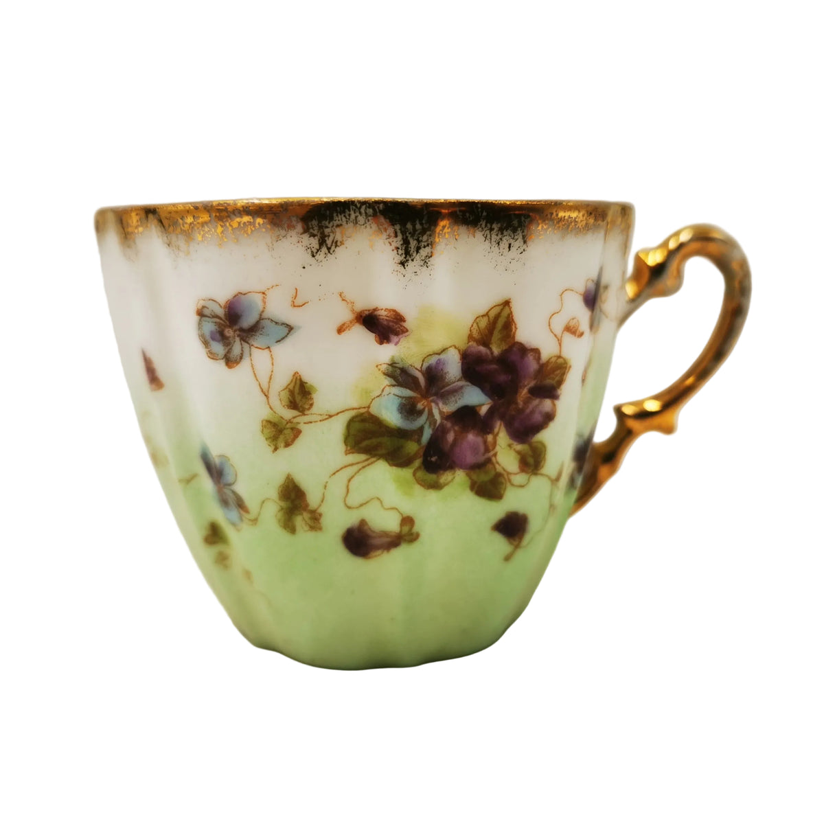 A vintage porcelain teacup with a pale green base, decorated with purple and blue flowers, green leaves, and a gold rim and handle.