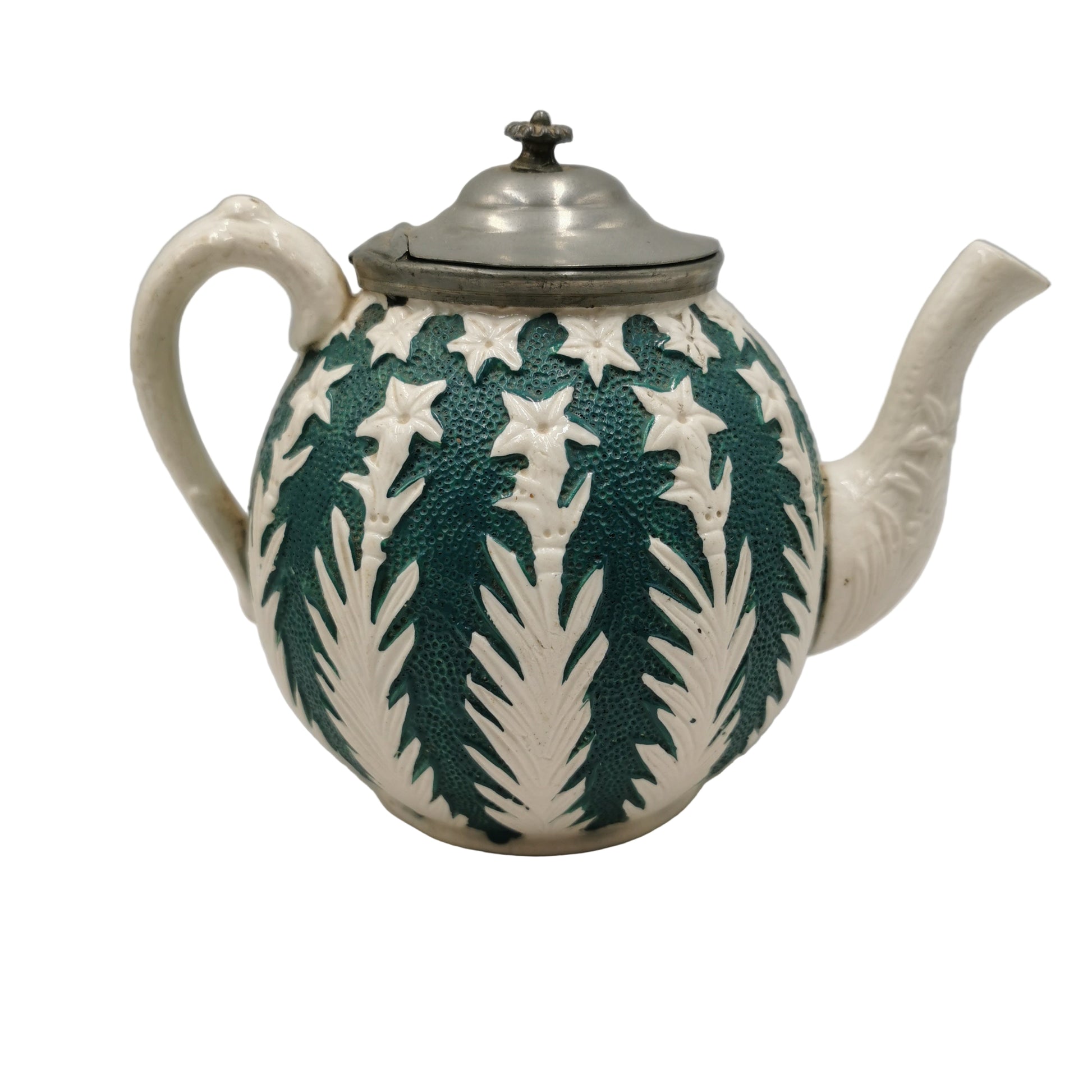 Ceramic teapot with green leaf pattern on a white background