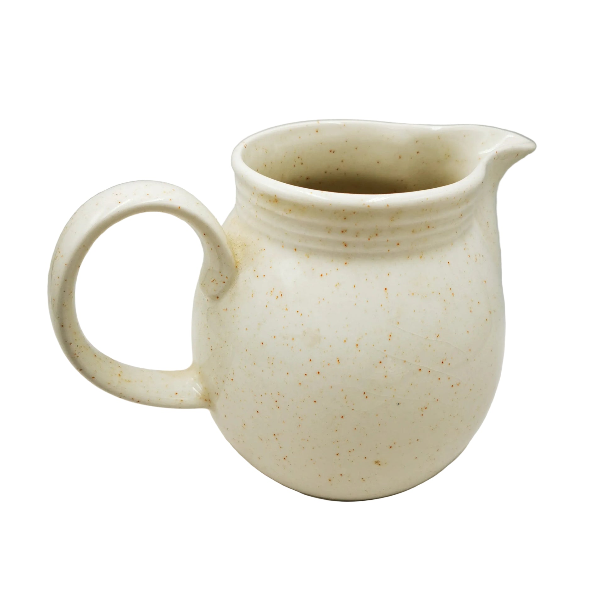White ceramic pitcher with speckled texture on a gray background