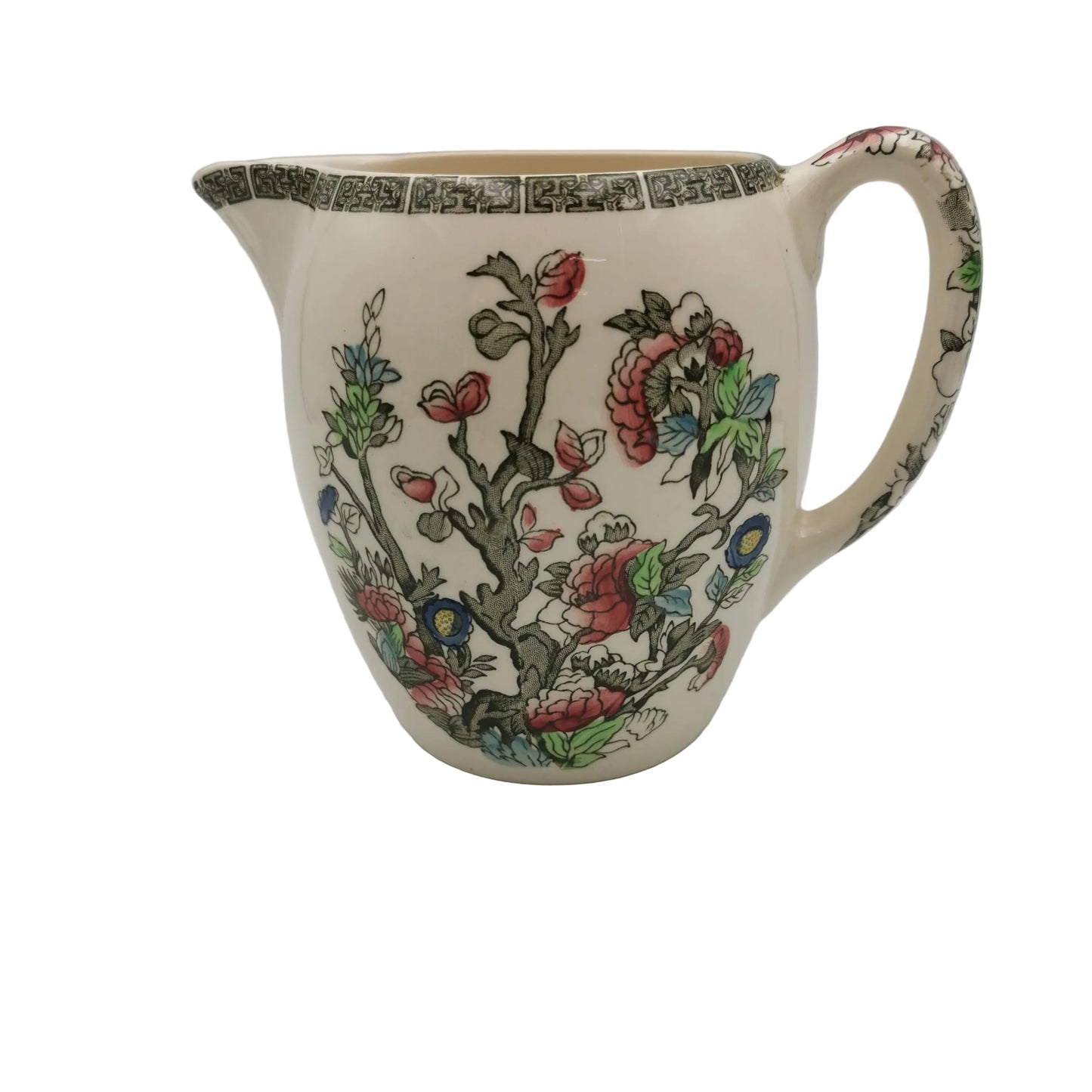 Ceramic pitcher with floral design on a plain background