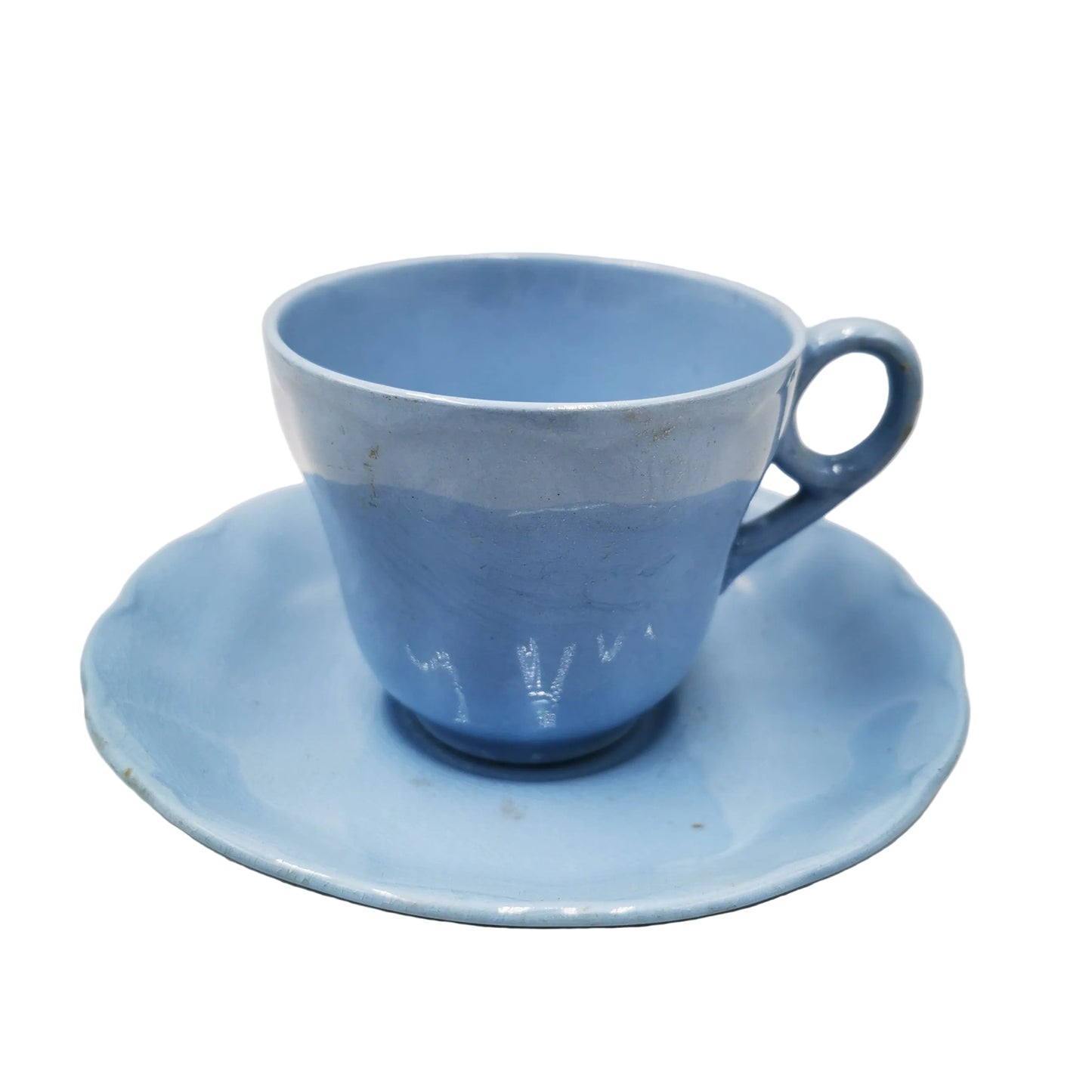A light blue ceramic teacup with a matching saucer, photographed against a neutral light gray background.