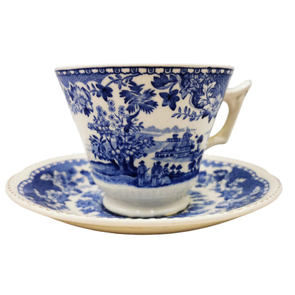Blue and white floral teacup and saucer on a light background