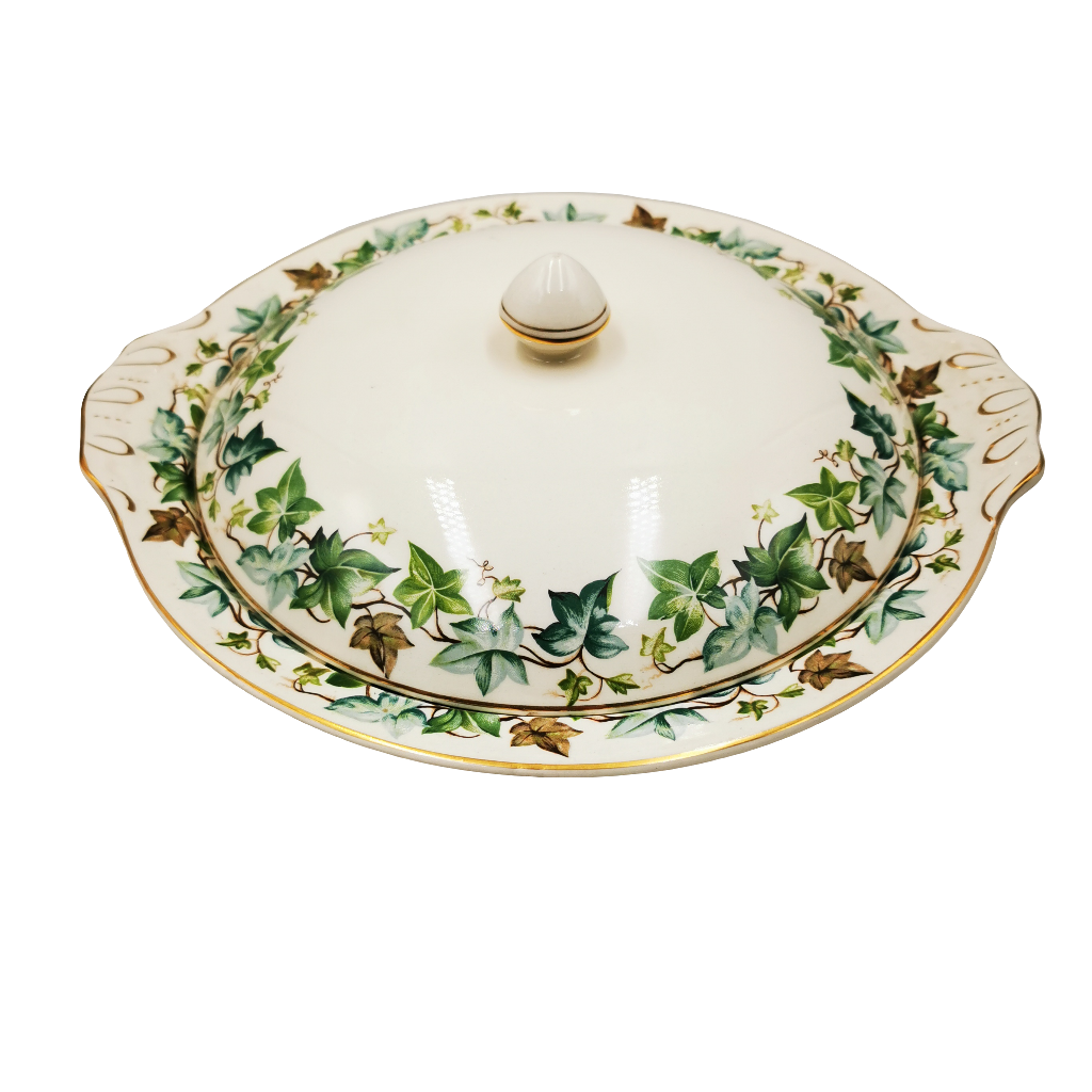 Decorative ceramic dish with a lid featuring ivy leaf pattern on a white background