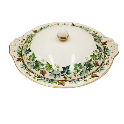 Decorative ceramic dish with a lid featuring ivy leaf pattern on a white background