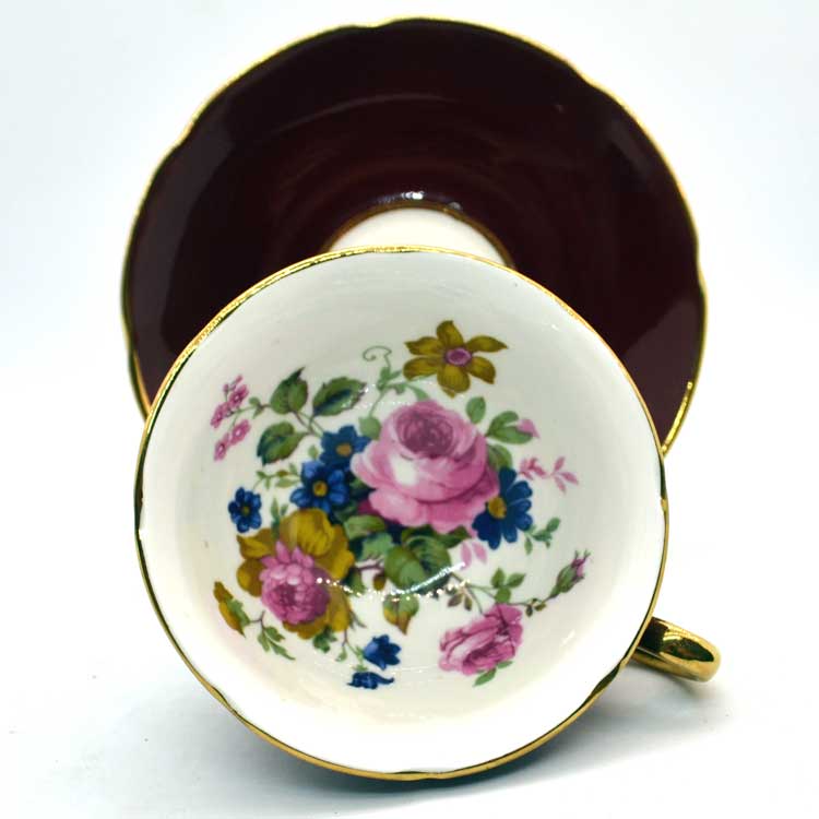 Floral tea cup and saucer flowers and maroon glaze